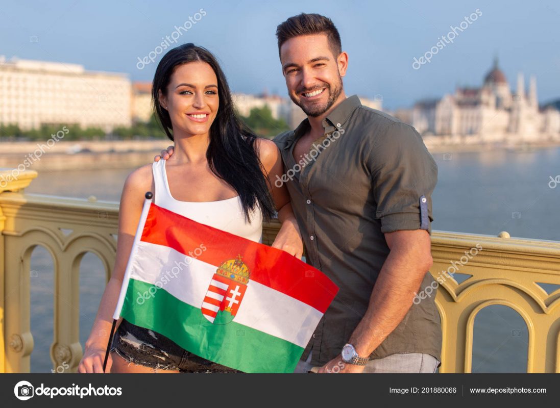 Happy young couple with hungarian flag smile at Budapest